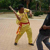 SGM Undo Caburnay demonstrating tapi-tapi hitting techniques with Master Nonoy.