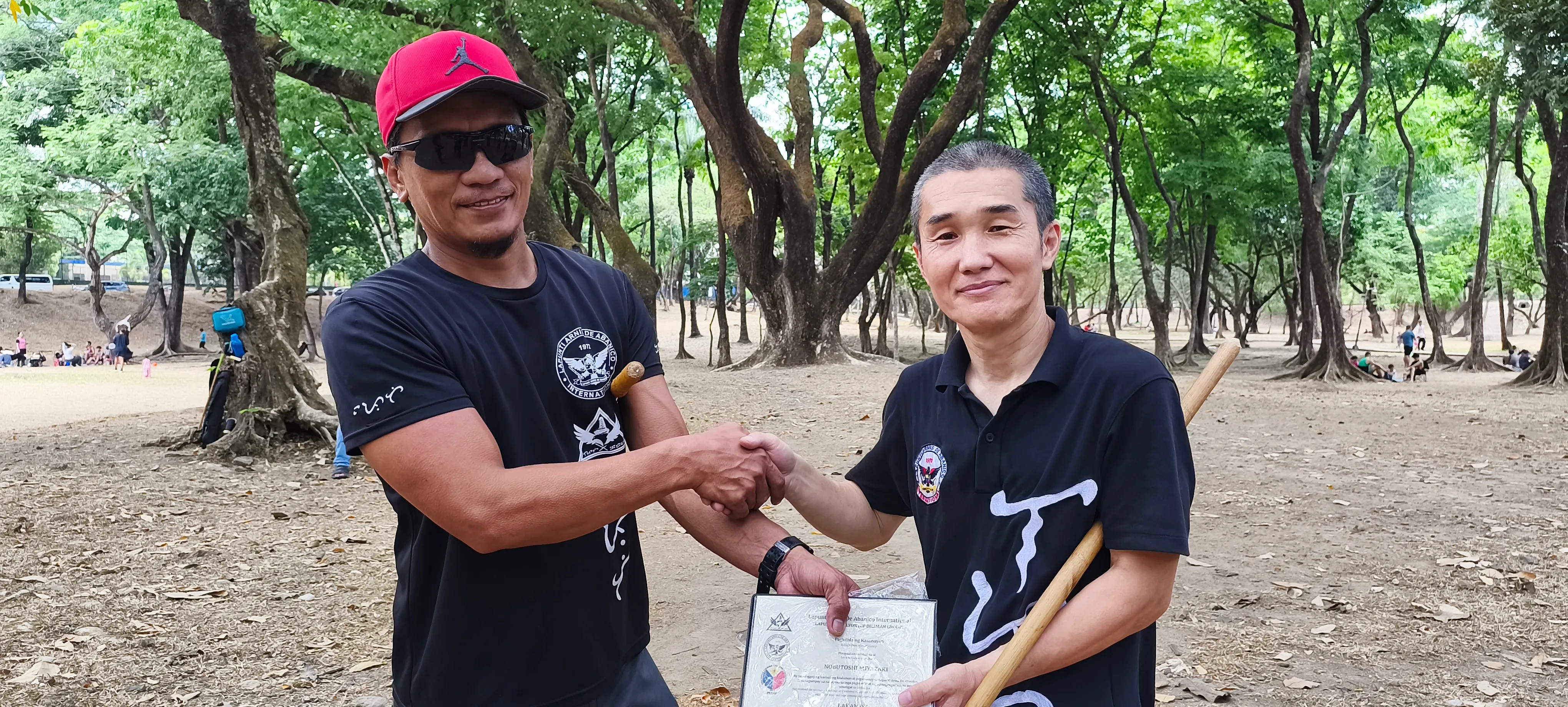 NB Miyazaki (R) receiving his certificate of promotion to the rank of Lakan Isa from Lapunti Karilyon Chief Instructor, Senior Master Buboy Ador.